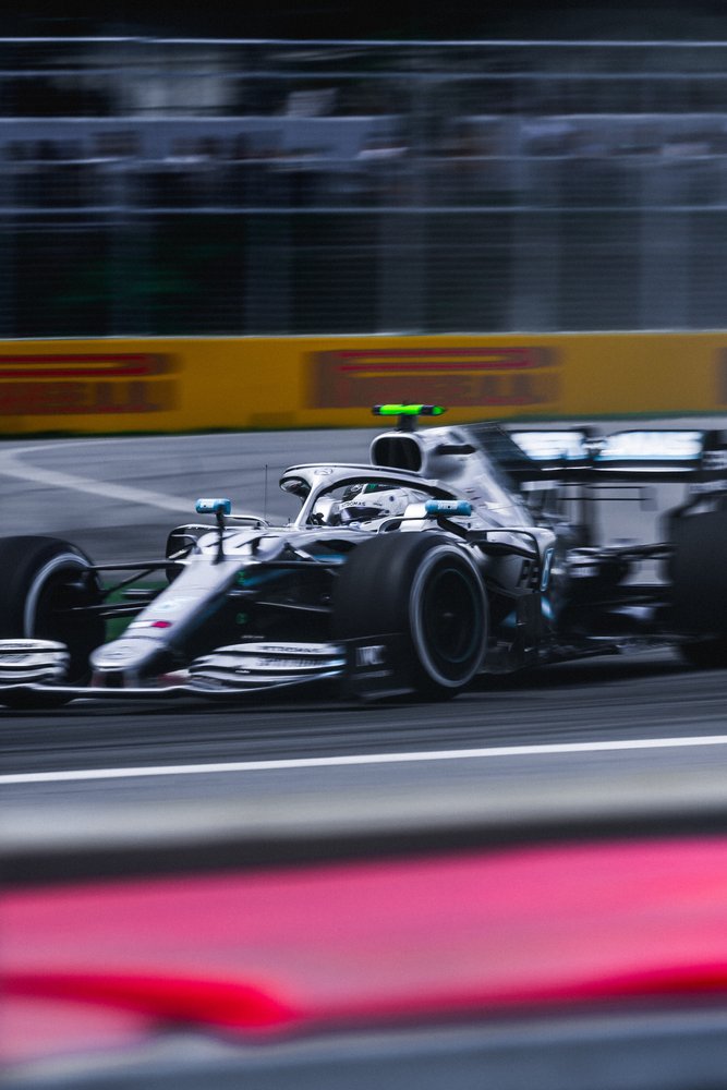 A racing car on a track, with a blurred background indicating high speed.